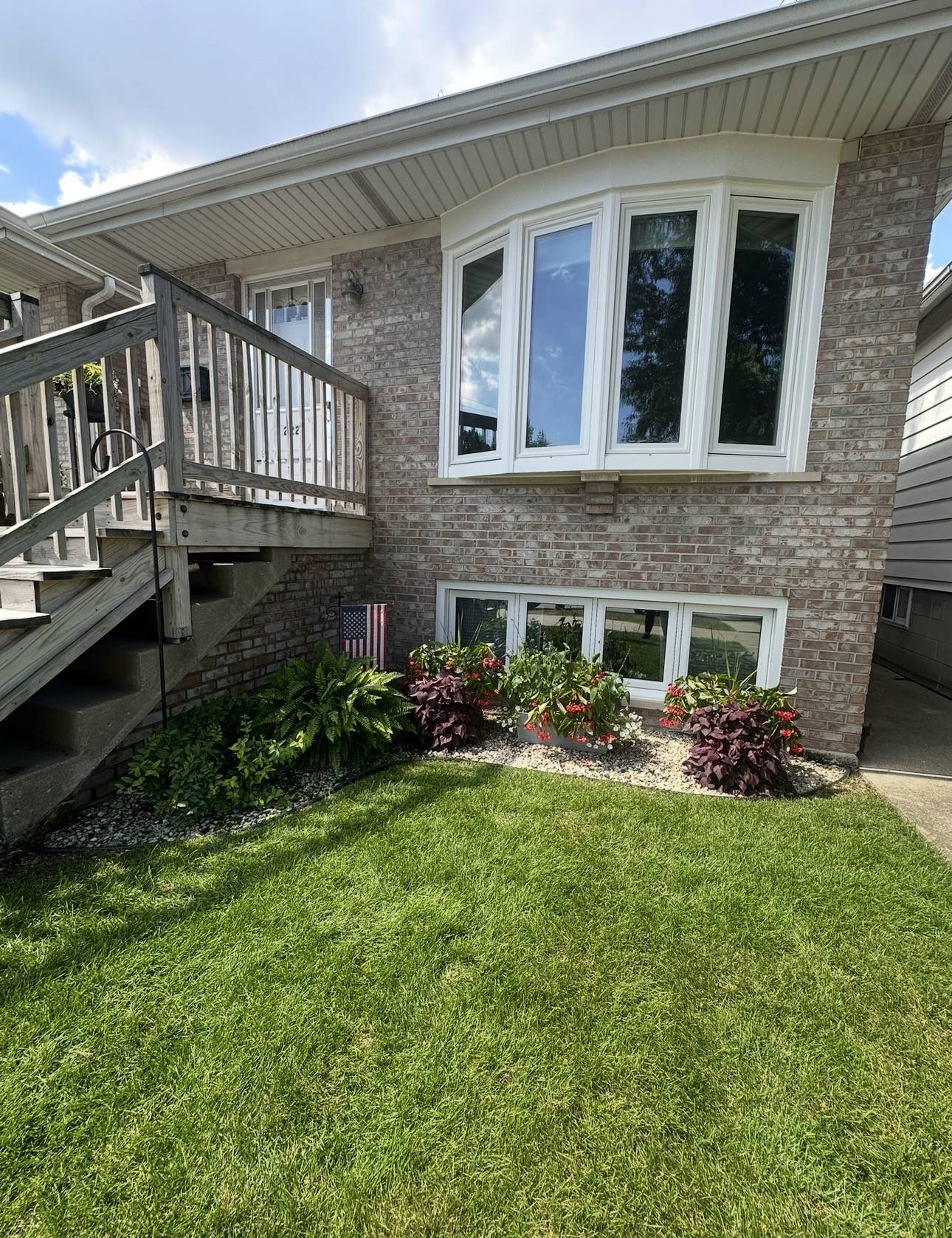 Detailed garden bed and lawn installation beside a residential home