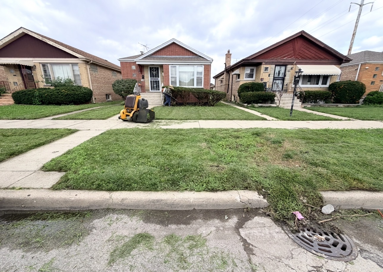 EZA Landscaping crew mowing and maintaining several neighborhood lawns